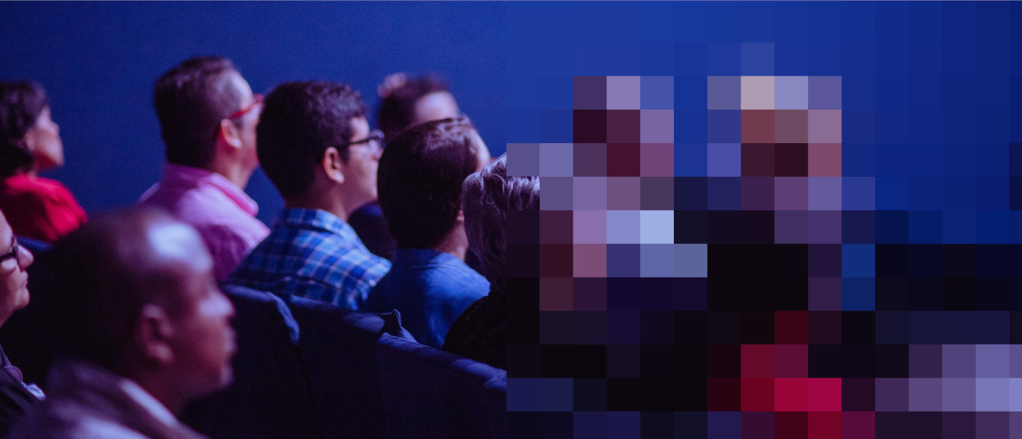 Audience seated in an auditorium.